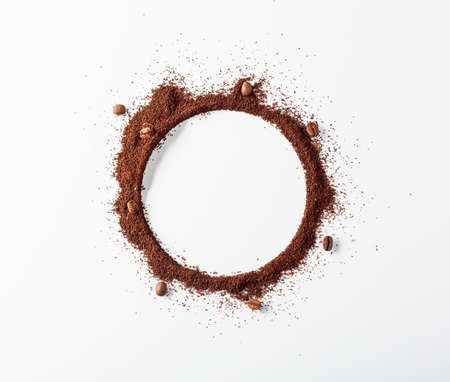 Coffee beans and coffee powder with round copy space. Top view.の写真素材