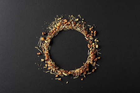 Herbal tea is scattered on a black background. Round copy space. Top view.の写真素材