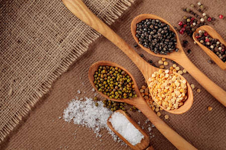 Various raw lentils with salt and pepper. Top view with copy space.