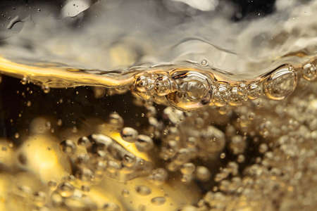 White wine in glass on black background, abstract splashing.の写真素材