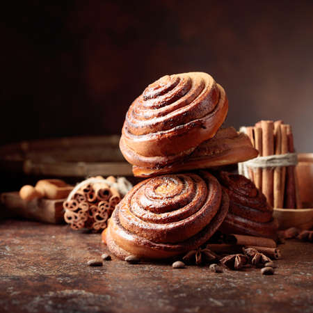 Freshly baked sweet buns sprinkled with cinnamon powder. Copy space.の写真素材