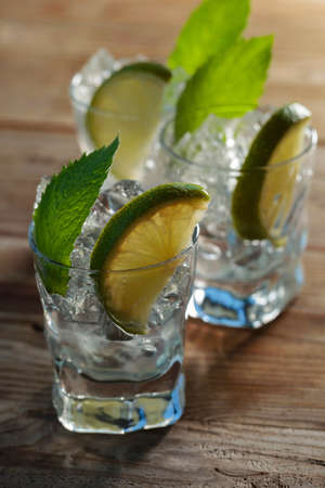 Alcoholic drink with lime, ice, and mint leaves.の写真素材