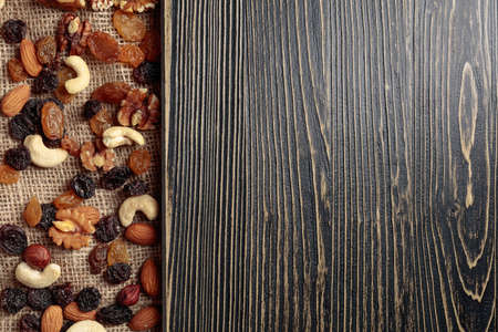 Dried fruits and nuts. The mix of nuts and raisins. Top view with copy space.
