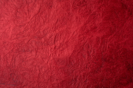 Textured crumpled red paper background. Top view.の写真素材