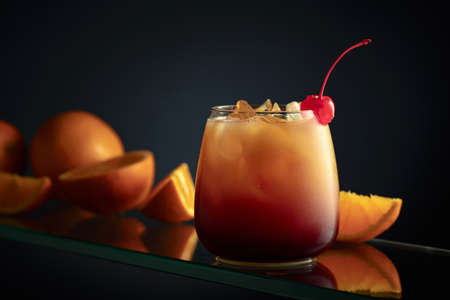 Tequila Sunrise alcoholic cocktail on a dark background.の写真素材