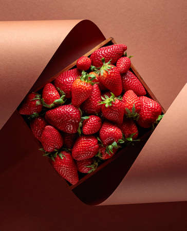 Fresh juicy strawberries in a wooden box. Copy space.