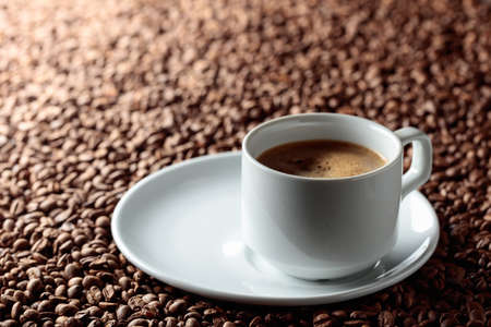 Black coffee in a white ceramic cup. Copy space.