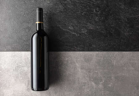 Bottle of red wine on a stone background. Top view.の写真素材