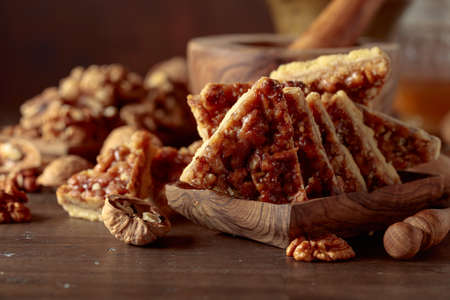 Cookies with walnuts and honey on an old wooden table.の写真素材