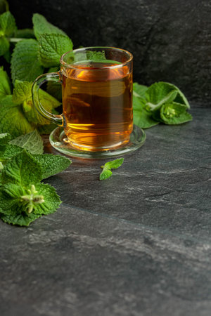 Mint tea in glass on a black table. Copy space.の写真素材