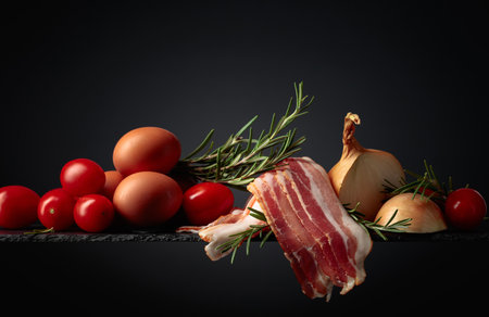 Smoked bacon with eggs, tomatoes, onions and rosemary. Copy space.