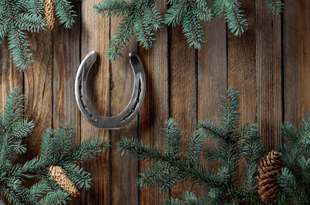 Horseshoe and spruce branches. Old wooden background. Copy space.の写真素材