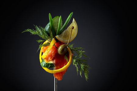 Smoked salmon with dill, cucumber, capers, green onion, and lemon slice. Copy space.の写真素材