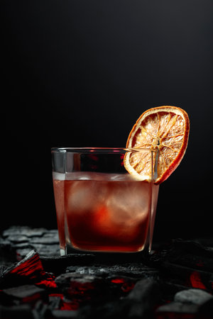 Old-fashioned cocktail with ice and dried orange slice.の写真素材