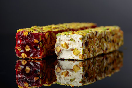 Traditional Turkish delight on a black reflective background.の写真素材