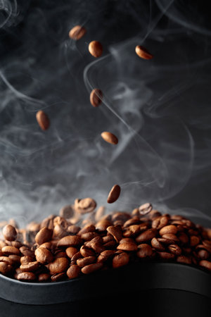 Steaming coffee beans in movement on a black background.