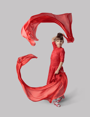 Dancing girl in a red dress with flying red fabric.の写真素材
