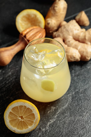 Ginger Ale with ice and lemon. Homemade lemon and ginger organic probiotic drink.