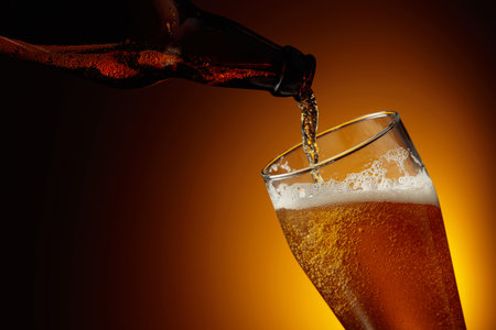 Pouring beer from a bottle into a glass. Copy space.の写真素材