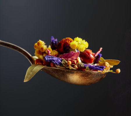 Mix of various dried medicinal plants and herbs for herbal tea on a black background.の写真素材