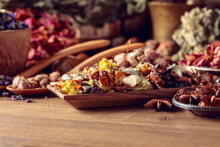 Various dried medicinal plants, herbs, and flowers on an old wooden background. Concept of herbal medicine or aromatherapy.の写真素材