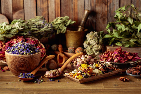Various dried medicinal plants, herbs, and flowers on an old wooden background. Concept of herbal medicine or aromatherapy.の写真素材