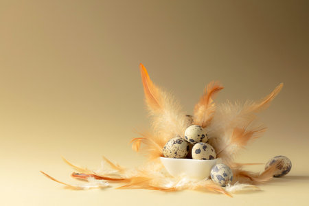 Quail eggs and feathers on a beige background. Copy space.