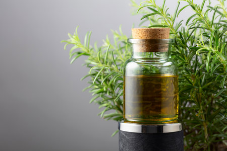 Rosemary essential oil and fresh rosemary. Copy space.