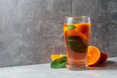 Summer cocktail with ice, mint, and orange. Copy space.の写真素材