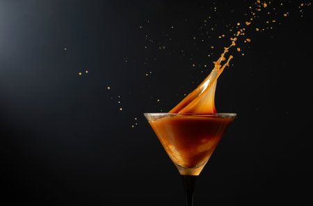 Chocolate martini drink with splashes on a black background. Copy space.