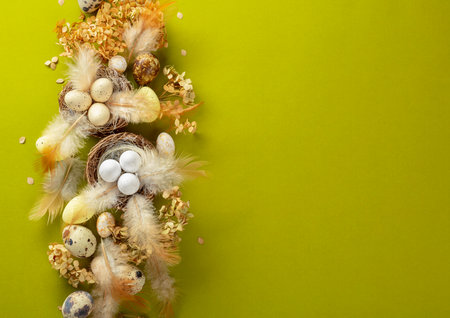 Easter composition with quail eggs, feathers, and dried flowers. Top view.の写真素材