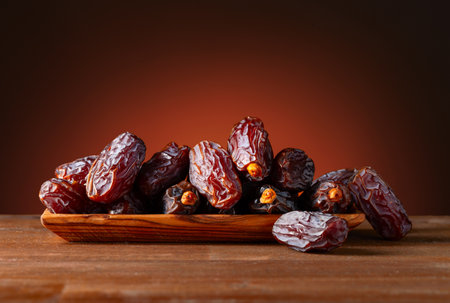 Juicy ripe dates on an old wooden table.の写真素材