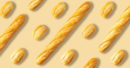 Baguettes and French buns on a beige background.