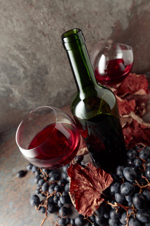 Red wine with blue grapes on vintage background. Wide angle shot.の写真素材