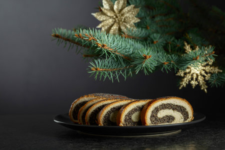 Poppy seed roll pieces on a black background. Traditional Christmas pastry. Copy space.の写真素材