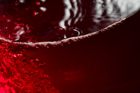 Red wine abstract splashing in glass. Macro shot. Copy space.