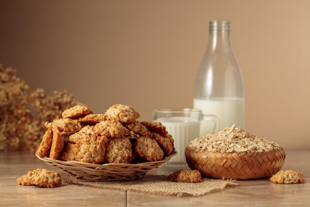 Oatmeal cookies and milk on a kitchen table. Beige background with copy space.の写真素材