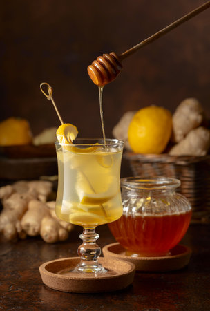 Ginger tea with lemon and honey on a brown background.の写真素材