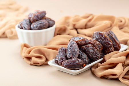 Dried medjool dates in white dish on a beige background.の写真素材
