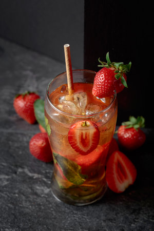 Hard seltzer or a summer refreshing drink with ice, mint, and strawberries.の写真素材