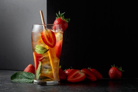 A summer refreshing drink with ice, mint, and strawberries. Copy space.の写真素材