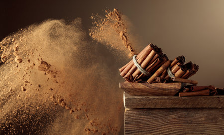 Cinnamon sticks on an old wooden table. Cinnamon powder explosion. Copy space.の写真素材