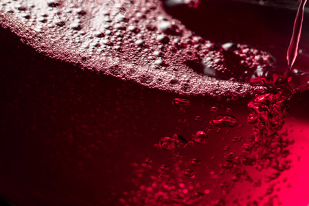 Red wine abstract splashing in glass. Macro shot. Copy space.の写真素材