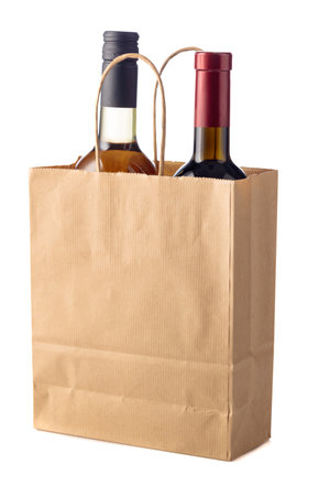 Bottles of red and white wine in paper bag isolated on a white background. Place your logo or text on a paper bag.の写真素材