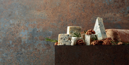 Blue cheese with walnuts, rustic bread, and fresh rosemary. A perfect harmony of flavors and textures, set in an elegant, cozy ambiance. Copy space for your text.の写真素材