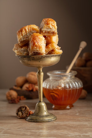Baklava with walnuts and honey on a beige background. Traditional East dessert.の写真素材
