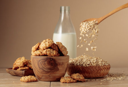 Oatmeal cookies and milk sit on a kitchen table. Beige background with copy space.の写真素材