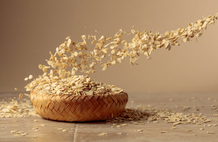 Oat flakes in motion on a beige background. Copy space.の写真素材