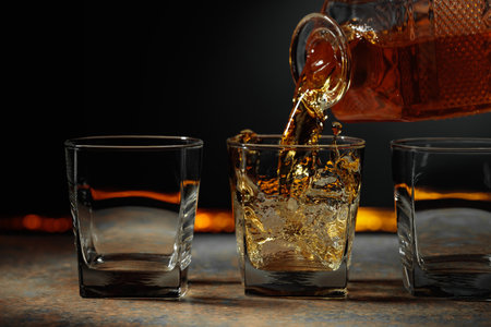 Whiskey is poured into a crystal glass. Copy space.の写真素材