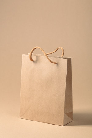 Paper bag on a beige background. Place your logo or text on a free space.の写真素材